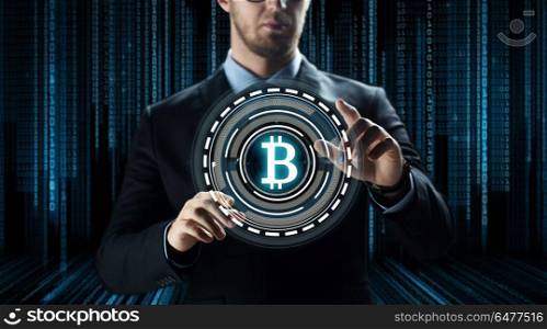 cryptocurrency, financial technology and business concept - close up of businessman with virtual bitcoin symbol hologram over and binary code and black background. close up of businessman with bitcoin hologram. close up of businessman with bitcoin hologram