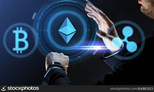 cryptocurrency, financial technology and business concept - close up of businessman with smart watch and virtual ethereum, bitcoin and ripple holograms over dark background. businessman with smart watch and cryptocurrency. businessman with smart watch and cryptocurrency