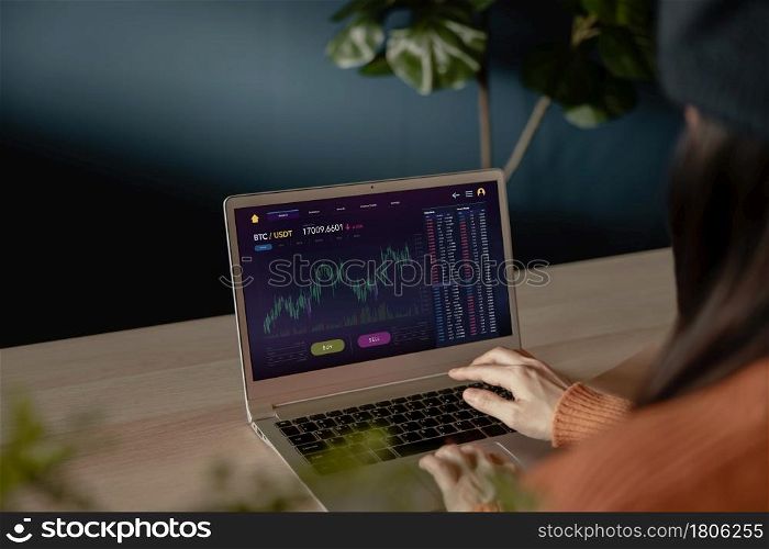 Cryptocurrency Investment Concept. Person Using Computer Laptop at Home to Buy and Sell Bitcoin via Online Exchange Platform. Blockchain,Fintech Technology. Innovation of Financial Investment