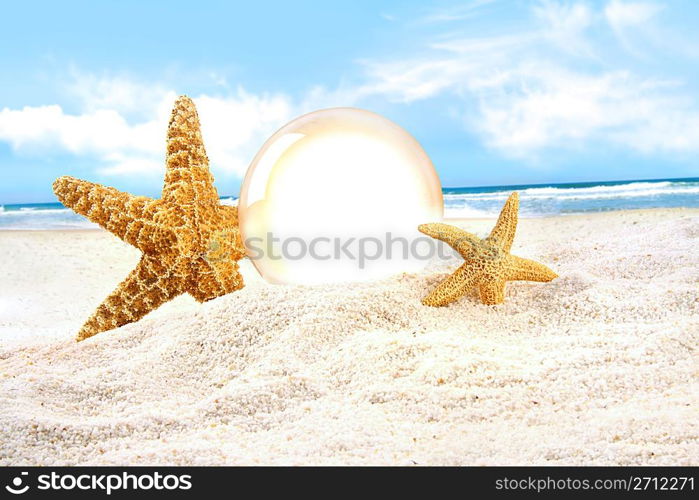 Crystal ball with starfish in the sand