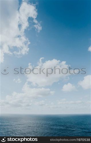 Crystal clear horizon of the ocean with white clouds with copy space, inspiration and freedom concept
