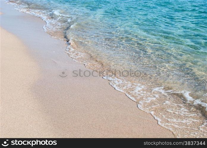 Crystal clear wave washing over sandy Black sea shore