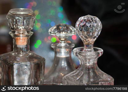 crystal glass whiskey bottles on reflective background