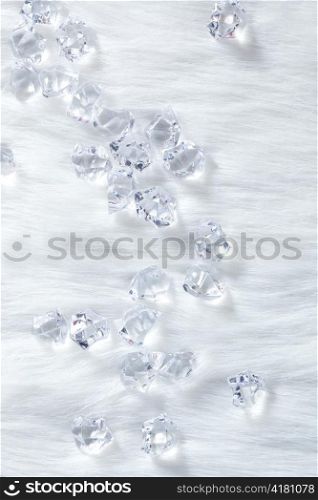 crystal ice cubes on winter white fur background