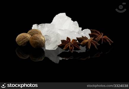 crystal sugar and spice over black reflective surface background
