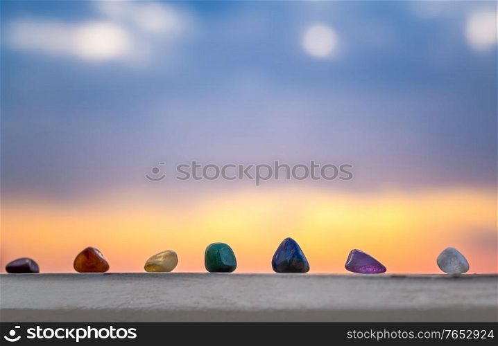 Crystals, energy stones for meditation over sunset background, inner peace, chakra cleansing and balance concept