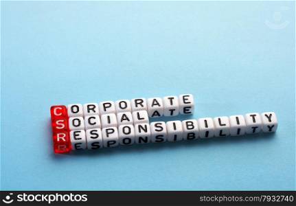 CSR Corporate Social Responsibility acronym on cubes on blue background