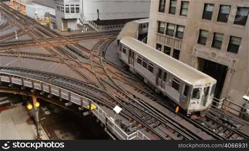 Cta trains running on elevated tracks of Metro Chicago. Commuters traveling by train to their offices in the financial district of Illinois in the United States of America. Subway crossing the exchanger train tracks area running through the center of the city in the downtown district.