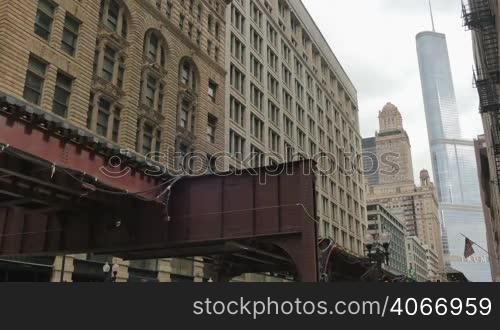 Cta trains running on elevated tracks of Metro Chicago. Commuters traveling by train to their offices in the financial district of Illinois in the United States of America. Subway running through the center of the city in the downtown district.