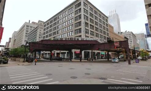 Cta trains running on elevated tracks of Metro Chicago. Commuters traveling by train to their offices in the financial district of Illinois in the United States of America. Subway running through the center of the city in the downtown district.