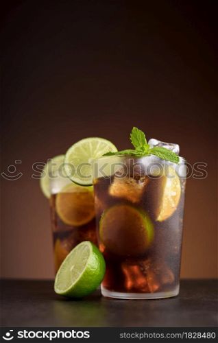 Cuba Libre cocktails. Alcoholic drinks with cola, rum, lime and mint. Cuba Libre or long island iced tea cocktails.. Cuba Libre cocktail. Alcoholic drink with cola, rum, lime and mint. Cuba Libre or long island iced tea cocktail.