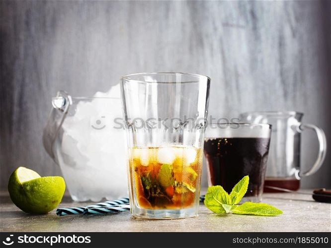 Cuba Libre with brown rum, cola, mint and lime