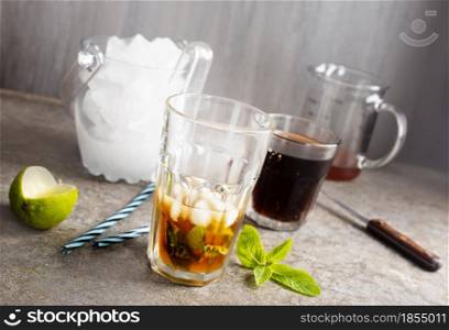Cuba Libre with brown rum, cola, mint and lime