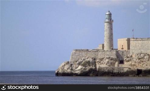 Cuban monuments and landmarks, lighthouse and Morro castle in Havana, Cuba, viewed from the Malecon, with Caribbean sea. Sequence