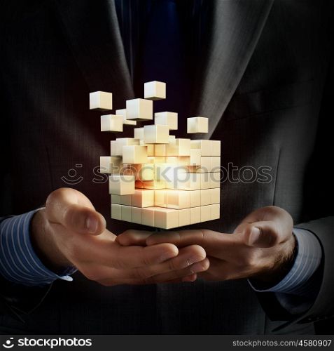 Cube in male hand. Businessman hand shows digital cube as thinking outside the box concept