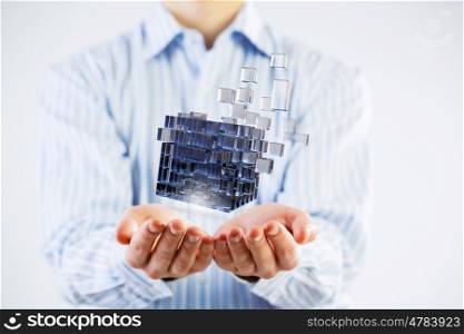 Cube in male hand. Conceptual image with 3D rendering cube figure in male palms