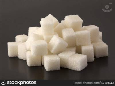 Cubes of sugar on black bacground