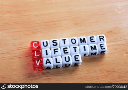 cubes with text CLV ,Customer Lifetime Value on wood