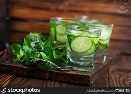cucumber drink in glass and on a table