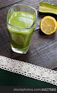 cucumber smoothie with lemon and sugar on wooden background