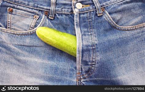 Cucumber sticking out of men's jeans like men penis.. Cucumber out of jeans like mens penis.