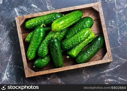 cucumbers in box and on a table