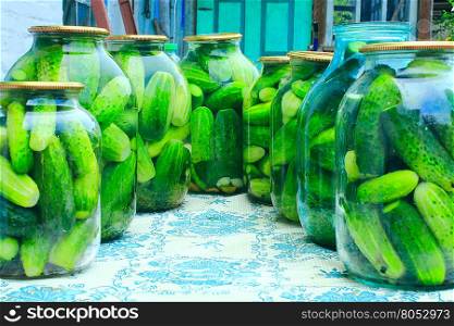 Cucumbers in the jars prepared for preservation. ripe cucumbers in the glass jars are prepared for preservation