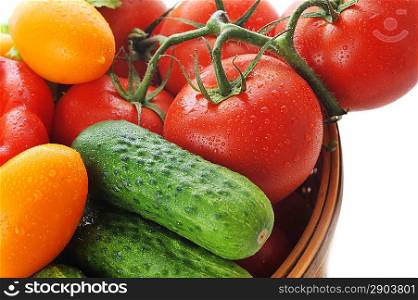 Cucumbers, red tomatoes lie in basket