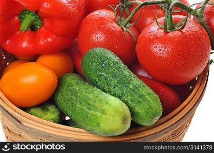 Cucumbers, red tomatoes lie in basket