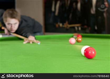Cue ball colliding with a red ball on a snooker table
