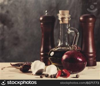 Cuisine still life with olive oil, spices and onion