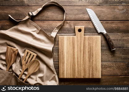 Culinary background, kitchen utensils and apron on kitchen countertop with blank space for any recipe or menu text