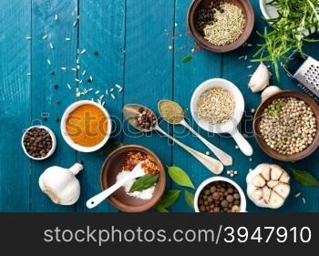 culinary background with spices on wooden table