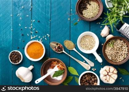 culinary background with spices on wooden table