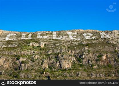 Cullera mountain with white sign writed on Valencia of Spain, sign non copyrighted
