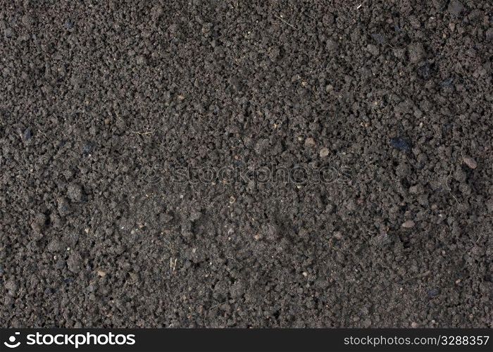 cultivated garden moist top soil background with clay and sand dominant components