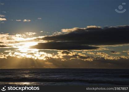 Cumulus clouds at sunset over ocean in Surfers Paradise, Australia.
