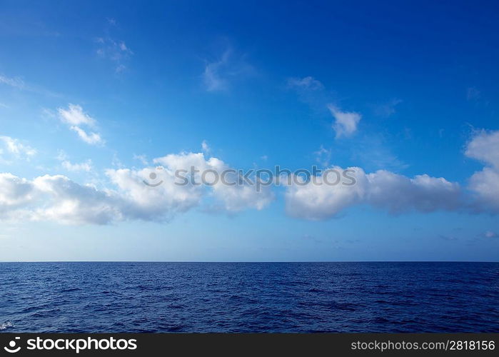 cumulus clouds in blue sky over ocean water horizon