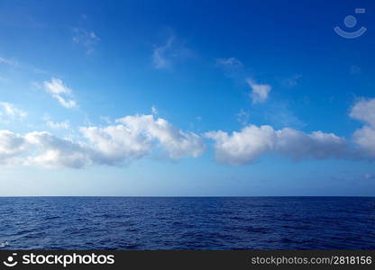 cumulus clouds in blue sky over ocean water horizon