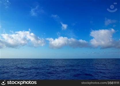 cumulus clouds in blue sky over ocean water horizon