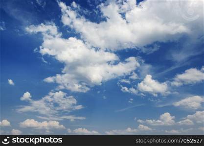 Cumulus white clouds on a dark blue sky background
