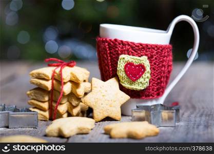 cup and beautiful delicious christmas gingerbread on a wooden table