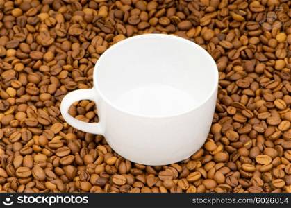 Cup and coffee beans isolated on the white