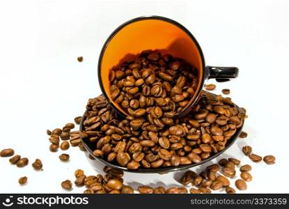 cup and saucer with the coffee beans isolated on white