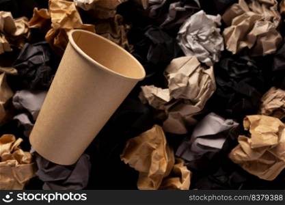 Cup and waste crumpled paper background texture. Recycling concept