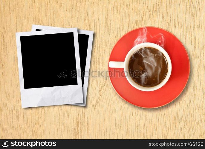 cup coffee and photo frame on wood background