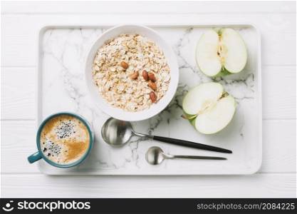 cup coffee oatmeal halved apple with spoons tray table
