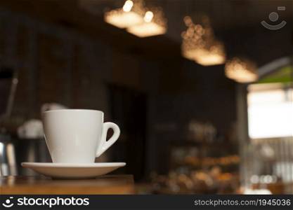 cup coffee with saucer table with defocus cafe background. High resolution photo. cup coffee with saucer table with defocus cafe background. High quality photo