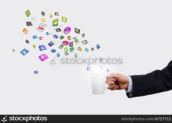 Cup in hand. Close up of businessman holding white cup with icons flying out