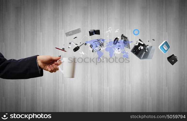 Cup in hand. Close up of businessman holding white cup with icons flying out